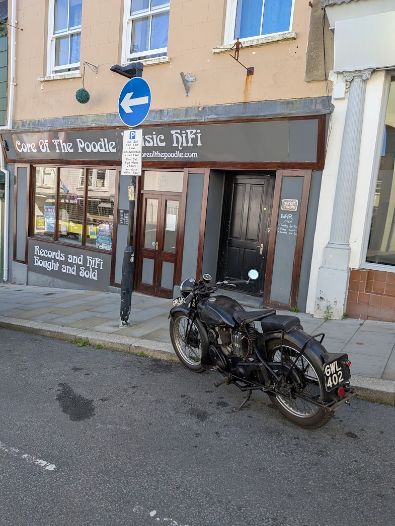 Core Of The Poodle shopfront with a vintage motorcycle parked outside